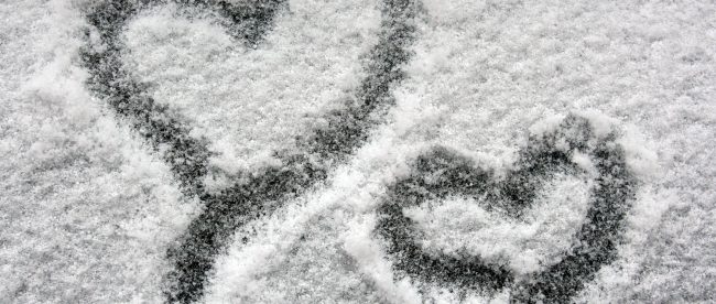 two hearts on snowy window