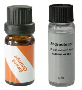 Sweet orange oil, in a brown screw-cap bottle with an orange and white label, sits next to pure AndrosteNOL, in a glass clear screw-cap bottle with a gray label.